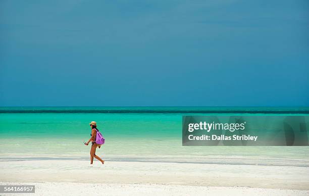 young woman walking along the beach, holbox island - holbox island stockfoto's en -beelden