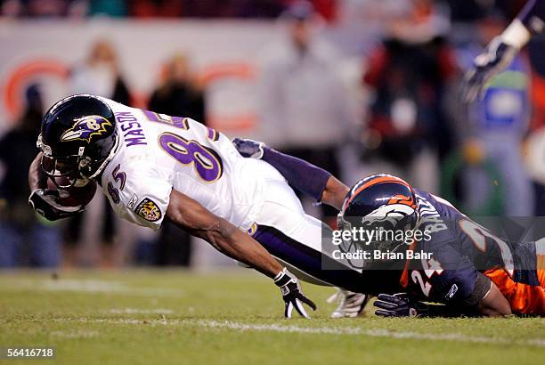 Cornerback Champ Bailey of the Denver Broncos stops wide receiver Derrick Mason of the Baltimore Ravens short of the goal line in the fourth quarter...