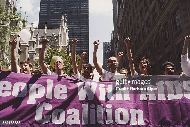 Members of the People With AIDS movement carry a banner during the Gay Pride parade in New York City, USA, June 29, 1986.