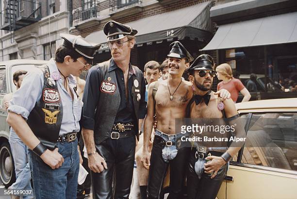 Group of men relax on the street during the Gay Pride parade in New York City, USA, June 27, 1982.