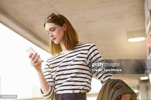woman commuter with mobile and suitcase waiting - sleeve stock pictures, royalty-free photos & images