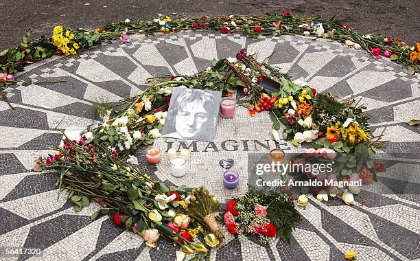 Flowers and a photo of musician, John Lennon, lie at the Strawberry Fields memorial December 11, 2005 in New York City. Lennon was shot and killed...