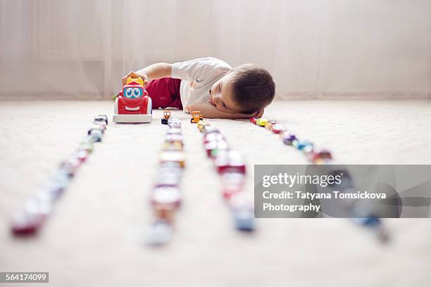 cute little boy, playing with toy cars at home - bohemia stock pictures, royalty-free photos & images