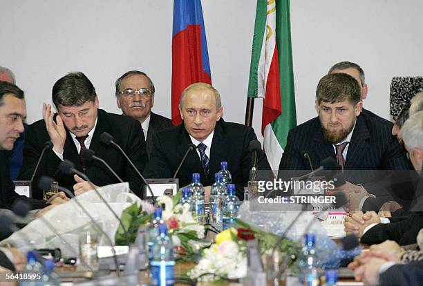 Russian President Vladimir Putin delivers a speech next to Chechen President Alu Alkhanov and Chechen Deputy Prime Minister Ramzan Kadyrov as he...