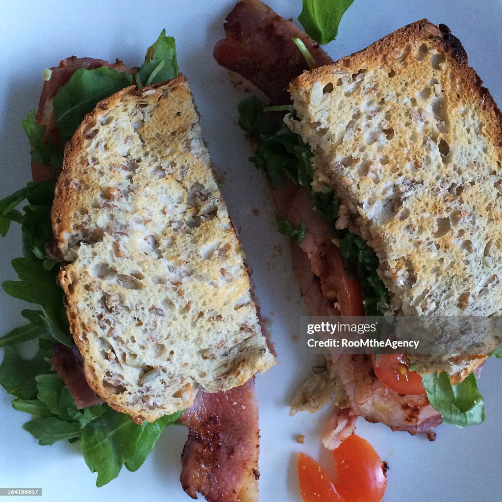 Overhead view of a bacon, rocket and tomato sandwich