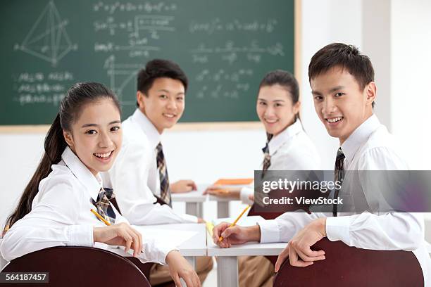 Four High School Students In The Classroom Learning High-Res Stock Photo
