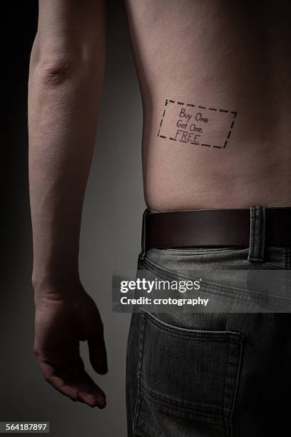 man with a buy one get one free tattoo on his back - buy one get one free stock pictures, royalty-free photos & images