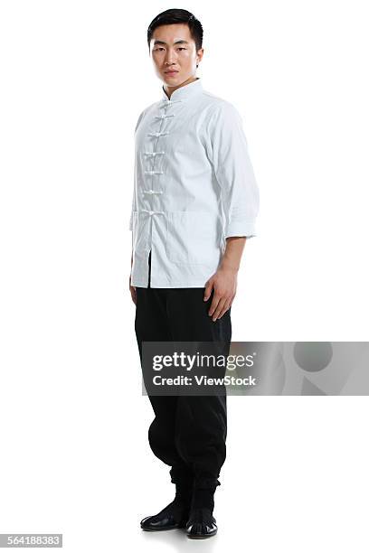 the young man wearing a martial arts clothing - chinese martial arts stock pictures, royalty-free photos & images