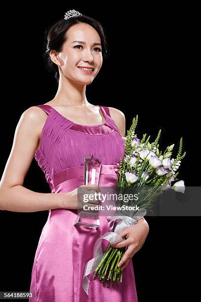 the young woman holding the trophy and flowers - the asian awards photos et images de collection