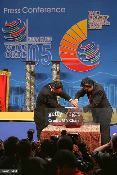 Secretary for Commerce, Industry & Technology John Tsang cuts barbecued pork during the opening ceremony of media center on 12 December, 2005 in Hong...
