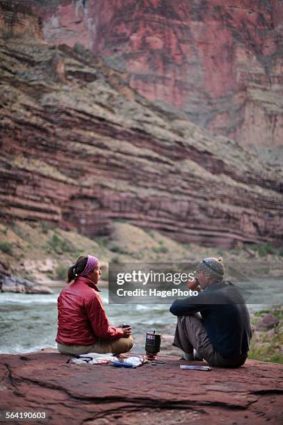 hikers cook dinner on a cliff-pinched patio above camp and the colorado river near deer creek falls in the grand canyon outside of fredonia, arizona november 2011. - deer creek falls bildbanksfoton och bilder
