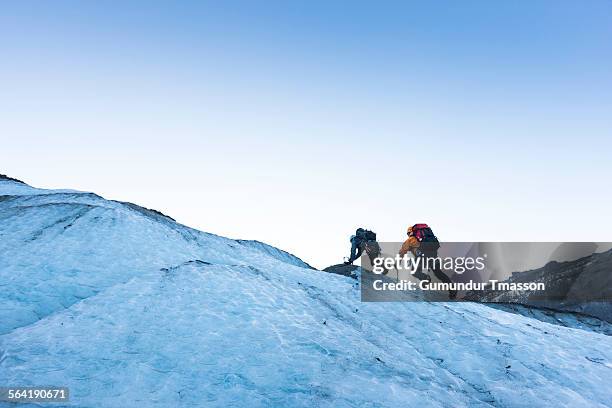 two climbers on an icelandic glacier. - eisklettern stock-fotos und bilder