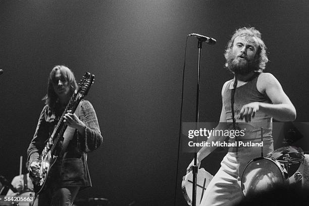 Bassist Mike Rutherford and singer Phil Collins performing on stage with English progressive rock group Genesis, April 1976.