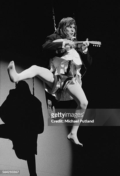 American-born British comedian and filmmaker Terry Gilliam performing with British comedy group Monty Python on stage at the New York City Center,...