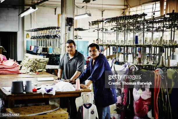 portrait of two workers in textile factory - textile factory stock pictures, royalty-free photos & images
