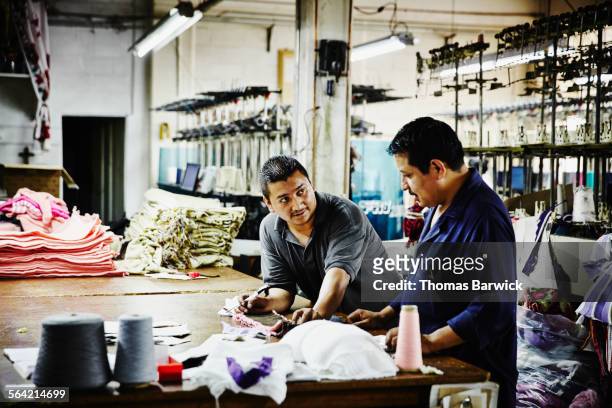 two workers in discussion at workbench in factory - pact for mexico stock pictures, royalty-free photos & images