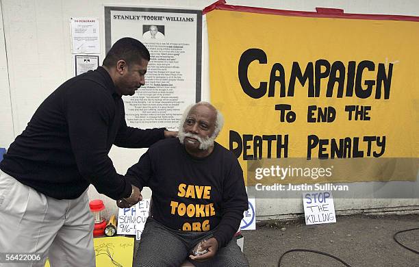 Death penalty opponent Fred Davis Jackson is consoled by Gonzalo Rucobo outside of San Quentin Prison after hearing that California Governor Arnold...