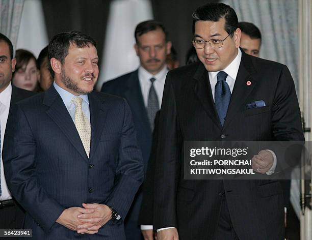 Thai deputy Prime Minister Surakiart Sathirathai talks with Jordan's King Abdullah II shortly after the latter's arrival at Military airport in...