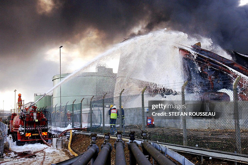 Firefighters continue to pour foam onto