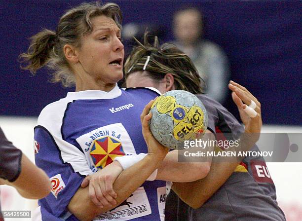 Romanian Simona Silvia Gogirla attacks as Stefanie Melbeck of Germany stops her during their handball match of the XVII Women's World Championship in...