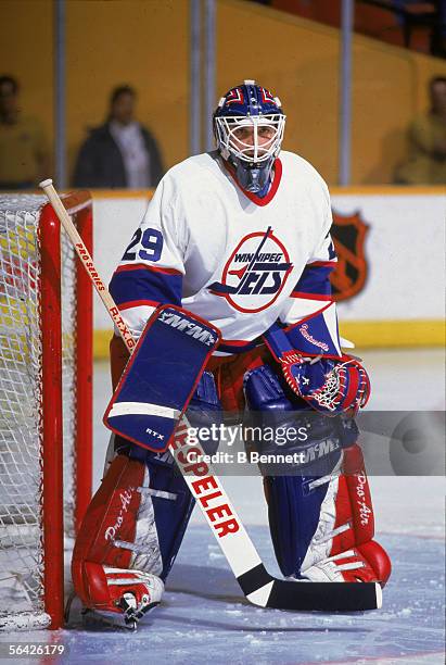 Canadian professional hockey player Tim Cheveldae, goalie for the Winnipeg Jets, defends the goal during a game at the Winnipeg Arena, Winnipeg,...