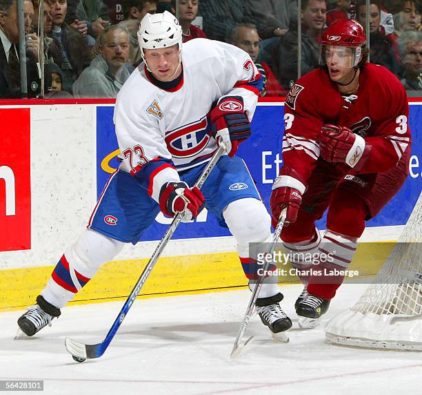 Michael Ryder of the Montreal Canadiens handles the puck defended by Denis Gauthier of the Phoenix Coyotes during NHL action at the Bell Centre on...