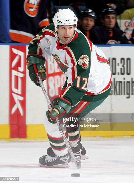 Brian Rolston of the Minnesota Wild controls the puck against the New York Islanders during their game on December 13, 2005 at Nassau Coliseum in...