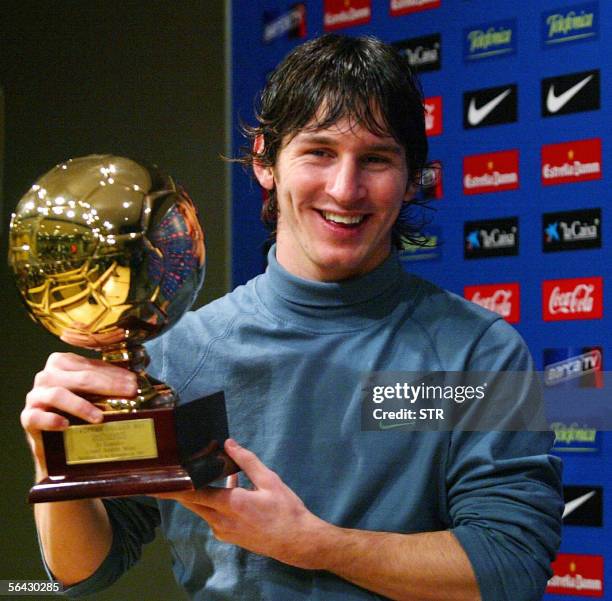 Barcelona's Argentinian forward Lionel Messi poses with his 'Golden Boy 2005' trophy awarded by Italian magazine 'Tuttosport' distinguishing the best...