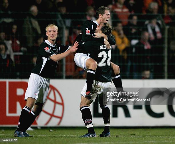 Kevin Hansen of Rostock celebrates the first goal with Tim Sebastian and Gledson during the Second Bundesliga match between LR Ahlen and Hansa...