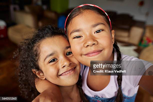 cute girls making selfie in living room - guancia a guancia foto e immagini stock