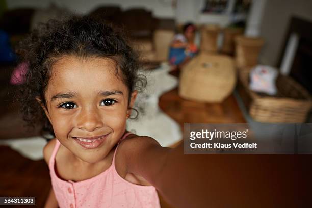 cute little girl making selfie in living room - black hair stock pictures, royalty-free photos & images