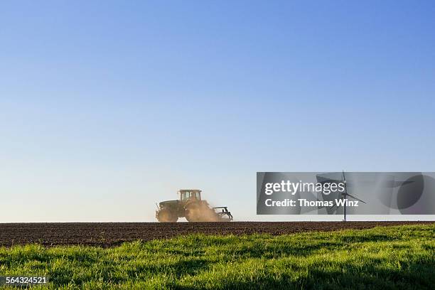 tractor and wind generator - landwirtschaft deutschland stock-fotos und bilder
