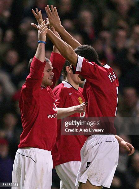Wayne Rooney of Manchester United celebrates scoring his team's third goal with Rio Ferdinand during the FA Barclays Premiership match between...