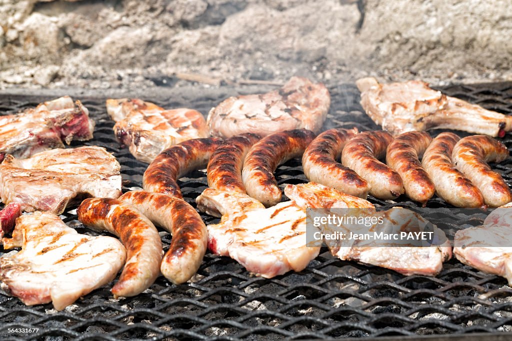 Chops and pork sausages cooked on the barbe