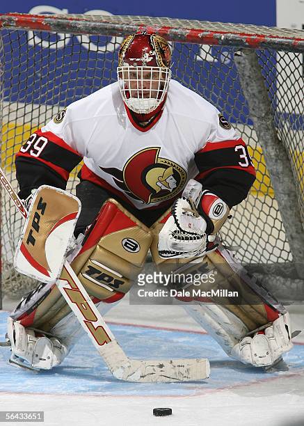 Goaltender Dominik Hasek of the Ottawa Senators warms up during an intermission to the NHL game against the Calgary Flames at Pengrowth Saddledome on...