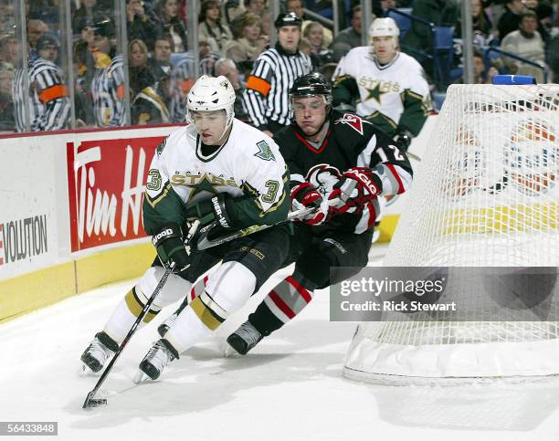 Stephane Robidas of the Dallas Stars skates ahead of Ales Kotalik of the Buffalo Sabres on December 14, 2005 at HSBC Arena in Buffalo, New York.