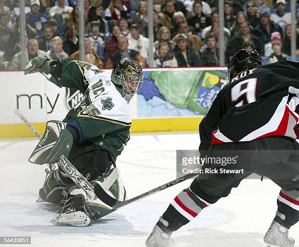 Derek Roy of the Buffalo Sabres scores on Marty Turco of the Dallas Stars on December 14, 2005 at HSBC Arena in Buffalo, New York.