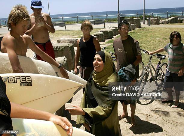 Nada Roude a representative of the Islamic Council of Australia talks to young Australian surfers at North Cronulla Beach near Sydney, 15 December...