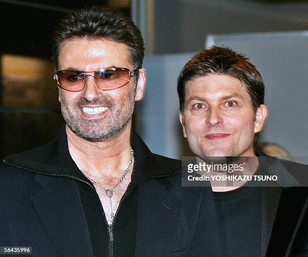 British pop star George Michael smiles with his partner Kenny Goss at a reception after the Japan premiere of his autobiographical movie "George...