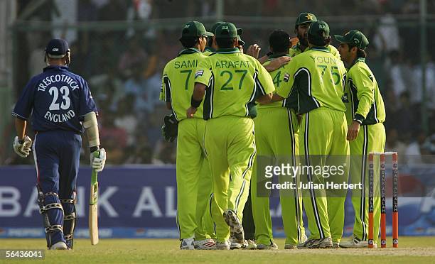 Players from the Pakistan team celebrate the dismissal of Marcus Trescothick during the 3rd One Day International between Pakistan and England played...