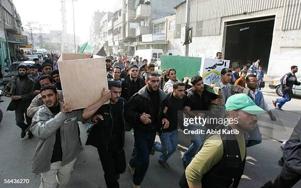 Mourners carry the bodies of Mohammed Joha and Rashad Al-Sen after their funeral at the al-Omary mosque December 15, 2005 in Gaza City, Gaza Strip....