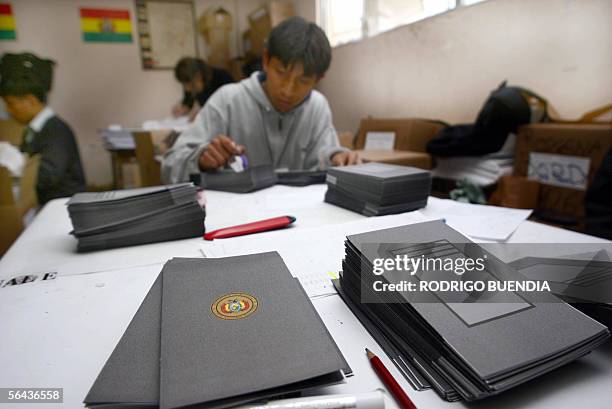 An employee of La Paz's Electoral Court stamps ballot papers to be used next Sunday during Bolivian national elections, in La Paz 15 december 2005....