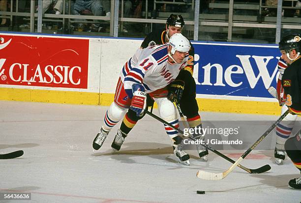 Canadian hockey player Mark Messier of the New York Rangers battles with Canadian Murray Craven and American hockey player Bret Hedican, both of the...
