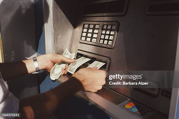 Man using a cash machine in New York City, USA, October 1983.
