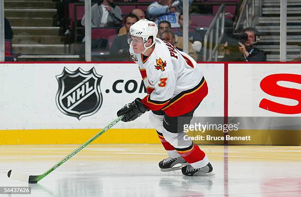 Dion Phaneuf of the Calgary Flames skates the puck out of the defensive zone against the New Jersey Devils at Continental Airlines Arena on December...