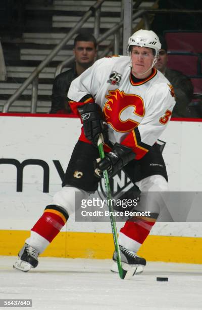 Dion Phaneuf of the Calgary Flames controls the puck during their game against the New Jersey Devils at Continental Airlines Arena on December 7,...