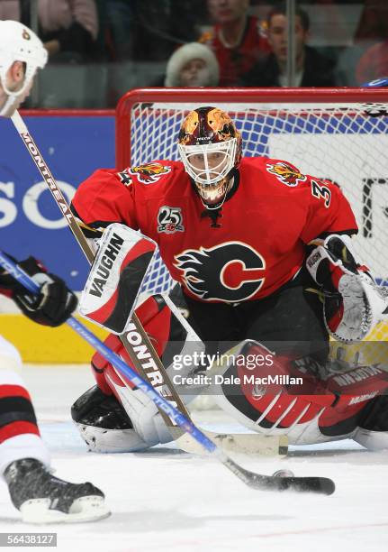 Goaltender Miikka Kiprusoff of the Calgary Flames makes a save against the Ottawa Senators during the NHL game at Pengrowth Saddledome on December...