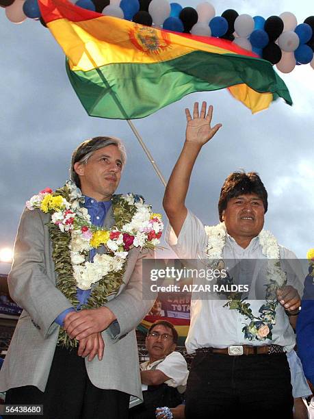 Presidential candidate coca grower and Aymara Indian leader Evo Morales , waves to supporters next to his vice presidential candidate Alvaro Garcia...