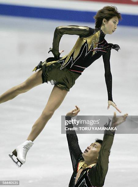 Zhang Hao of China tosses his partner Zhang Dan during their short program of pair event in the figure skating Grand Prix series final in Tokyo, 16...