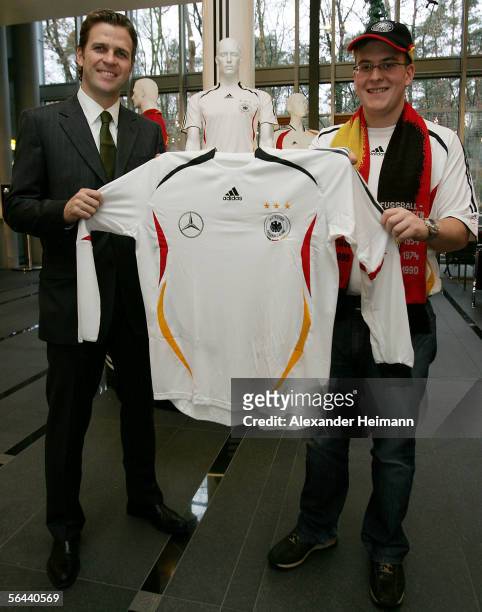 Football fan Matthias Schaller and manager of the German national football team Oliver Bierhoff pose during the DFB Honour for the 20,000 fan club...